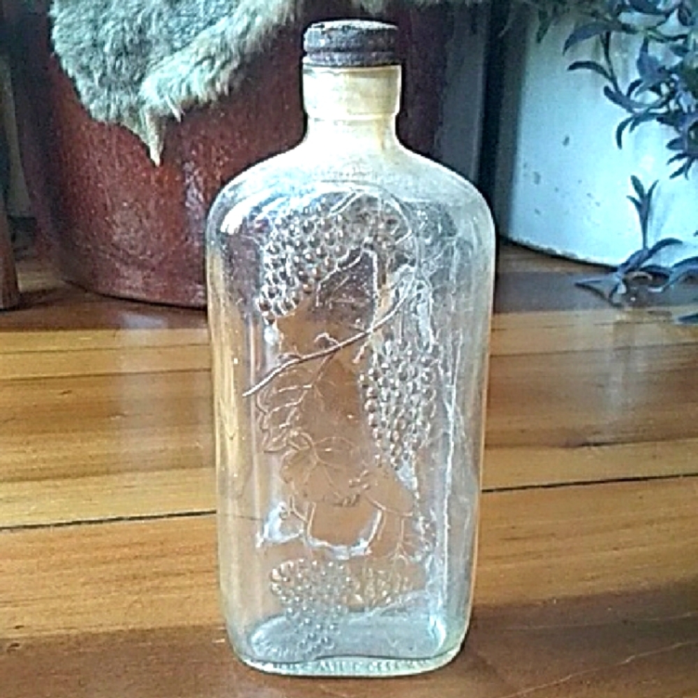 Vintage Clear Glass Bottle with Embossed Design